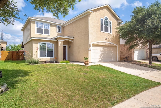 traditional-style house featuring fence, driveway, a front lawn, and stucco siding