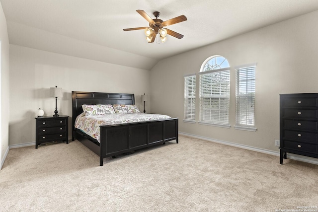 bedroom featuring lofted ceiling, light carpet, and baseboards