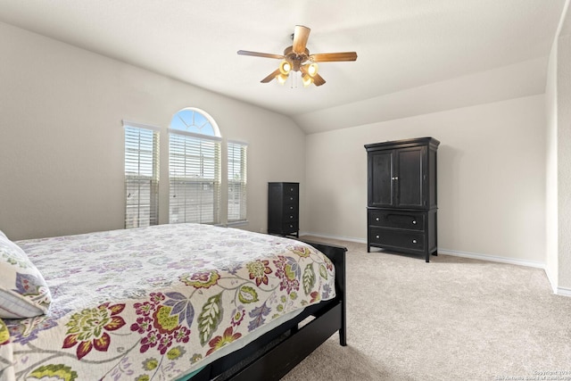 bedroom featuring light carpet, ceiling fan, baseboards, and lofted ceiling