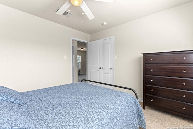 bedroom with a ceiling fan, light colored carpet, and visible vents