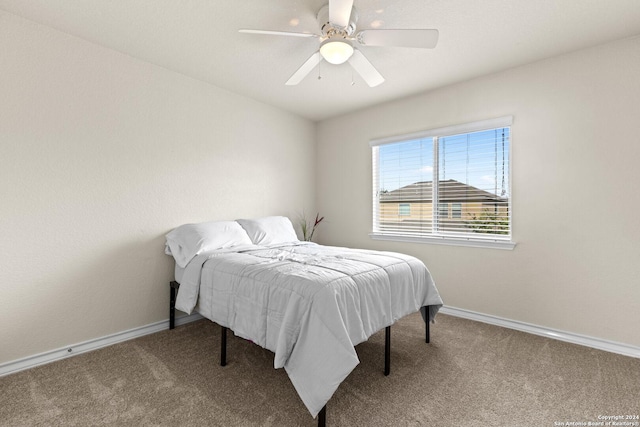 carpeted bedroom featuring a ceiling fan and baseboards