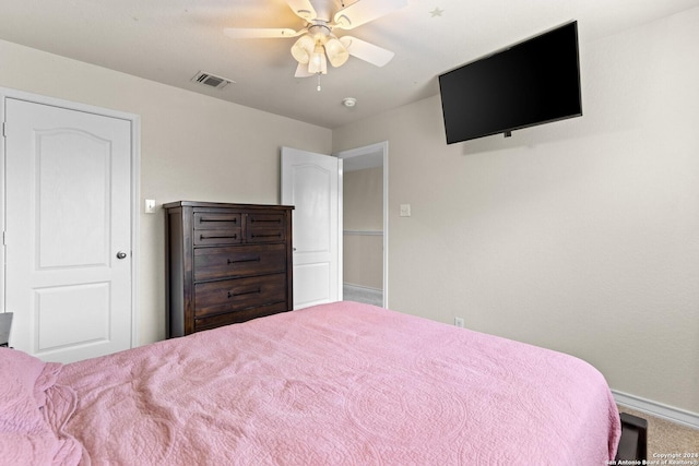 bedroom with a ceiling fan, visible vents, and baseboards