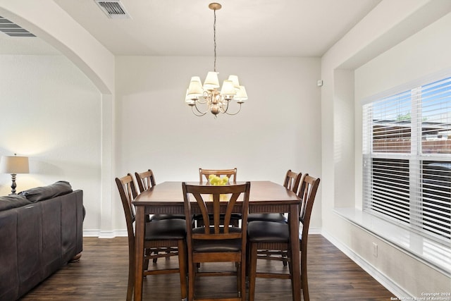 dining area with baseboards, dark wood finished floors, visible vents, and a notable chandelier