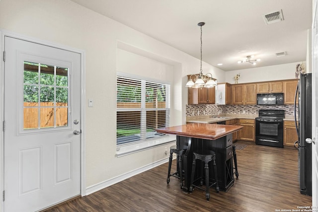 kitchen featuring black appliances, tasteful backsplash, dark wood finished floors, and visible vents