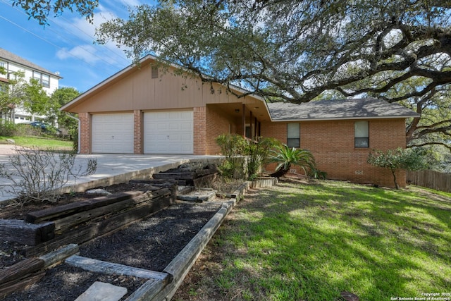 single story home with brick siding, an attached garage, and a front yard