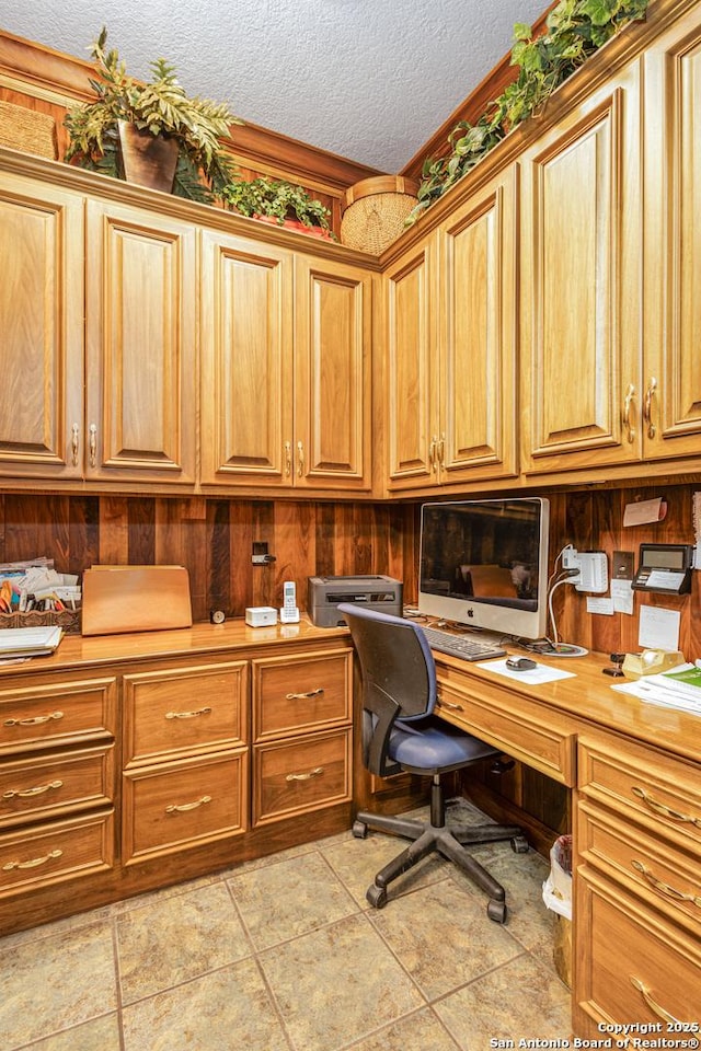 office with a textured ceiling and built in study area