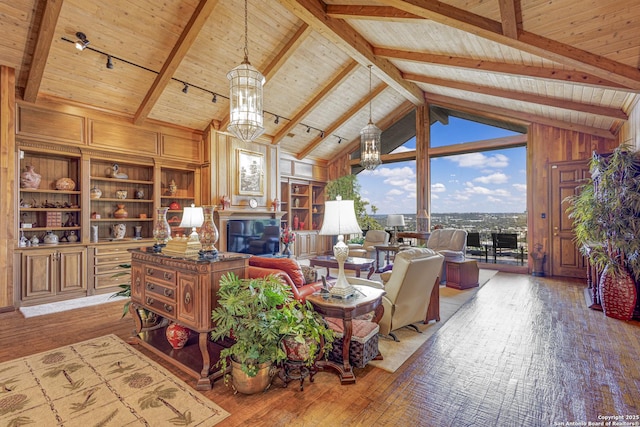 living room with light wood-type flooring, wooden ceiling, a glass covered fireplace, and wooden walls