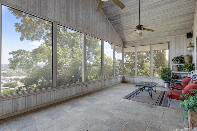 unfurnished sunroom with vaulted ceiling and a ceiling fan