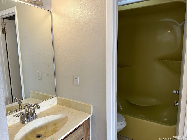 bathroom with toilet, shower / washtub combination, and vanity