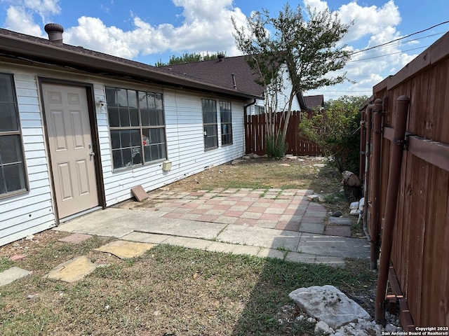 exterior space with a patio and a fenced backyard