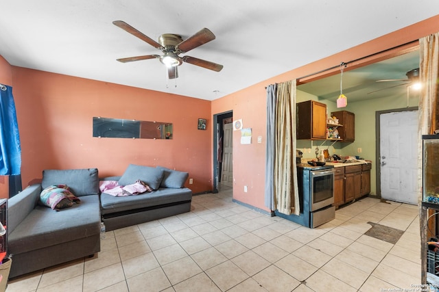 living room featuring light tile patterned floors, a ceiling fan, and baseboards