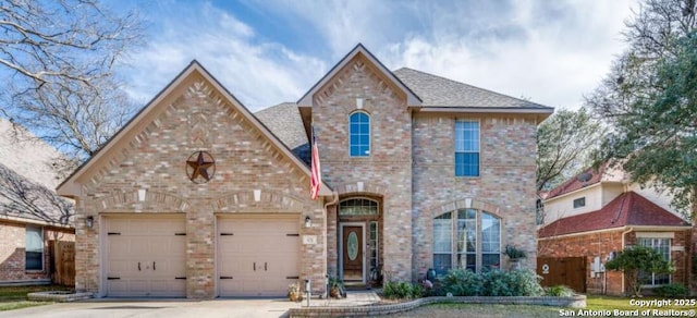 view of front of home with a garage, concrete driveway, brick siding, and roof with shingles