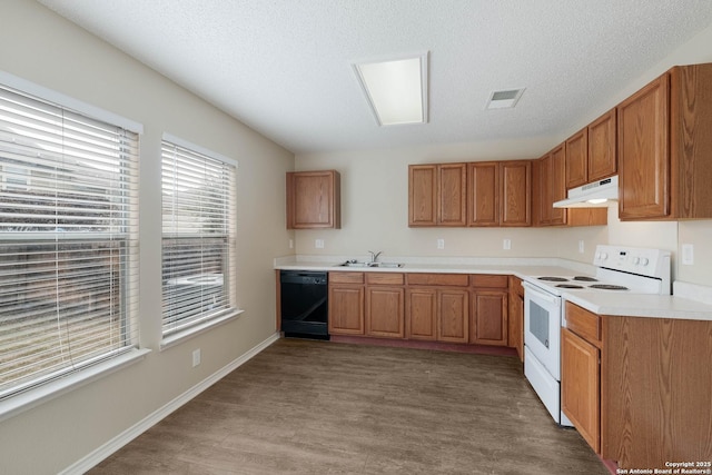 kitchen with under cabinet range hood, electric range, a sink, dishwasher, and brown cabinetry