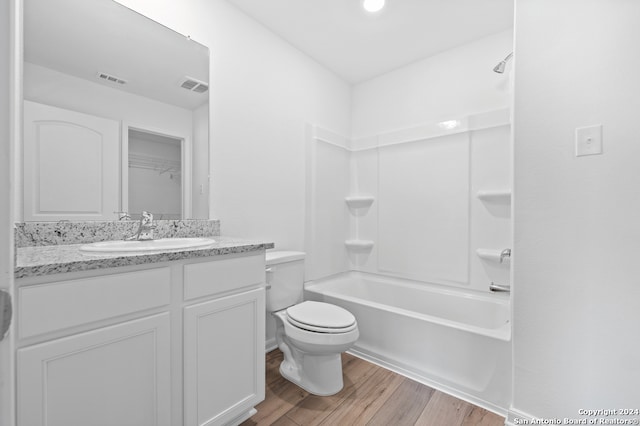 full bath featuring visible vents, vanity, toilet, and wood finished floors