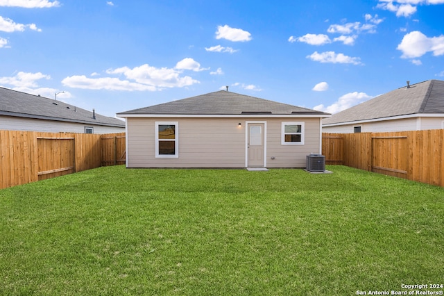 back of house with a lawn, cooling unit, and a fenced backyard