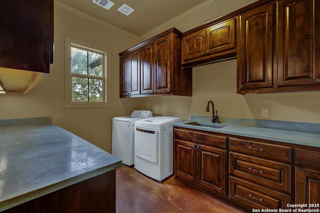 laundry room featuring cabinet space, visible vents, ornamental molding, washing machine and dryer, and a sink