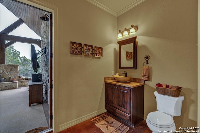 bathroom with baseboards, vanity, toilet, and crown molding