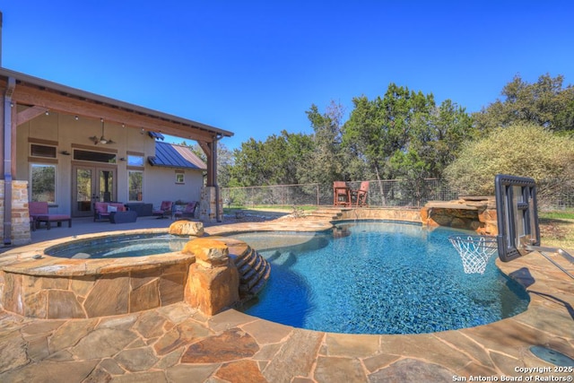 view of swimming pool with a fenced in pool, french doors, a patio area, fence, and an in ground hot tub