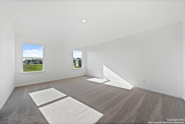 empty room with carpet floors, recessed lighting, and baseboards