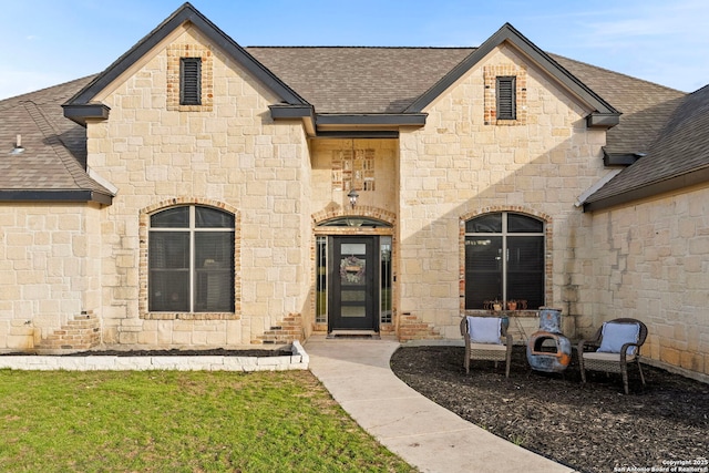 property entrance featuring roof with shingles