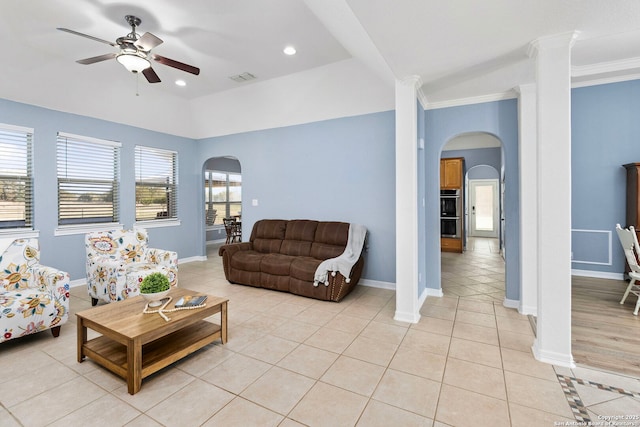 living room featuring arched walkways, a healthy amount of sunlight, visible vents, and light tile patterned floors