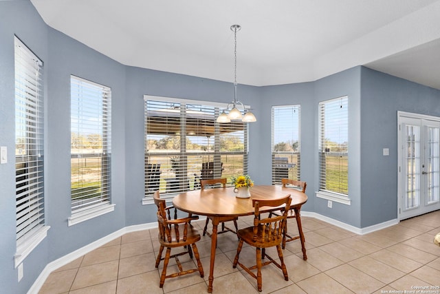 dining area featuring light tile patterned flooring and baseboards