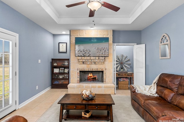 living area with plenty of natural light, a tray ceiling, and crown molding