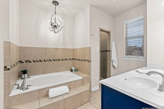 bathroom with a chandelier, a garden tub, tile patterned flooring, a sink, and a tile shower