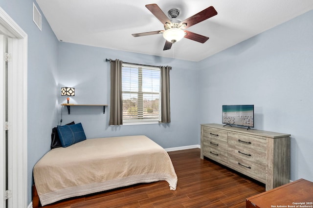 bedroom featuring a ceiling fan, baseboards, visible vents, and dark wood-type flooring