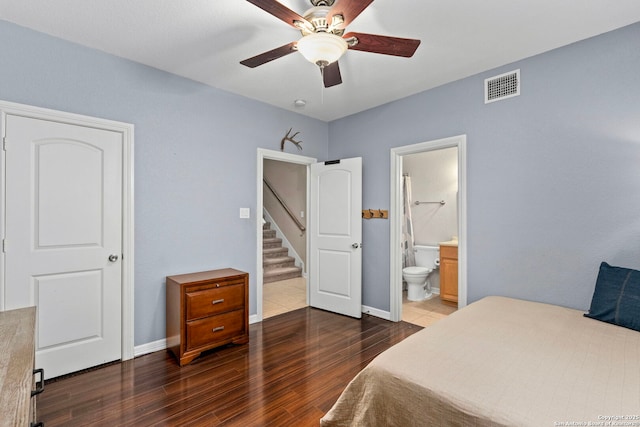 bedroom with baseboards, visible vents, connected bathroom, ceiling fan, and wood finished floors