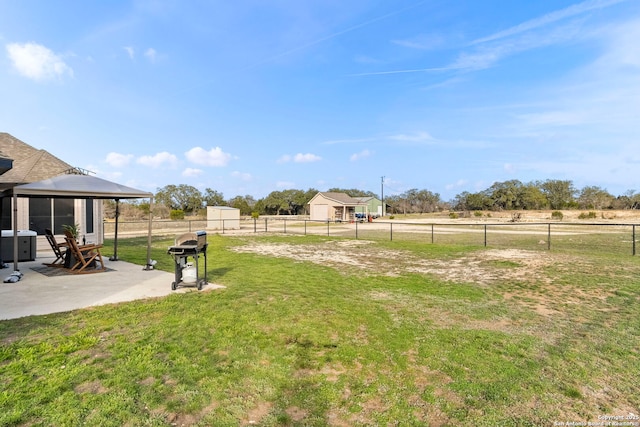 view of yard featuring a gazebo, a patio area, and a fenced backyard