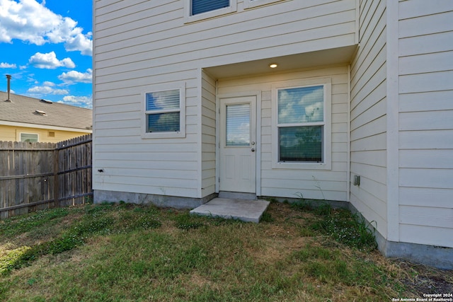 view of exterior entry with fence