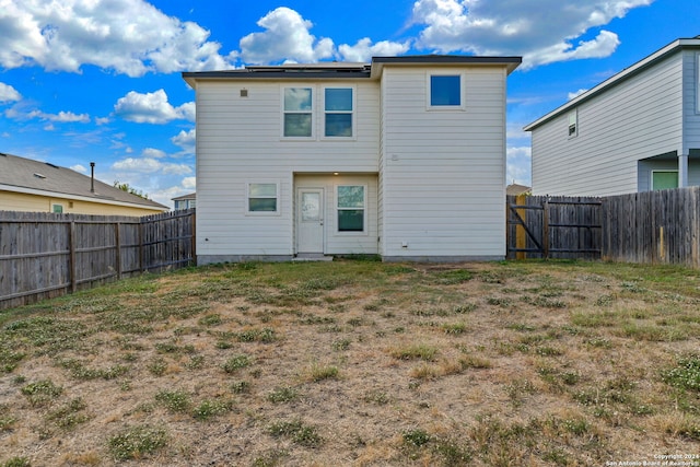 back of property featuring a fenced backyard