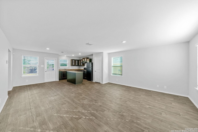 unfurnished living room featuring recessed lighting, visible vents, baseboards, and wood finished floors