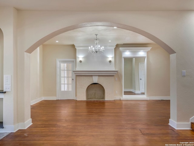 unfurnished living room featuring recessed lighting, a fireplace, wood finished floors, and baseboards