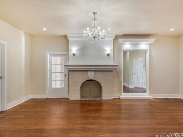 unfurnished living room with recessed lighting, a brick fireplace, wood finished floors, and baseboards