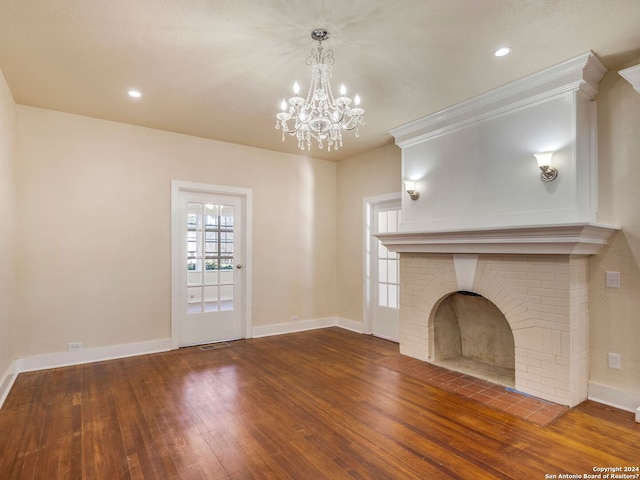 unfurnished living room featuring recessed lighting, visible vents, a brick fireplace, baseboards, and hardwood / wood-style flooring