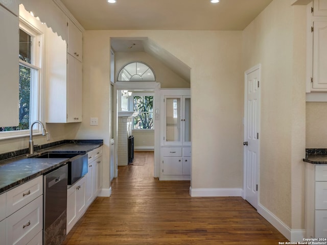 kitchen featuring white cabinetry, dishwasher, a sink, and wood finished floors