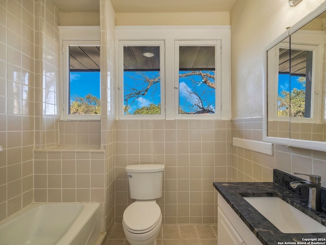 bathroom with tile patterned flooring, tile walls, toilet, and vanity