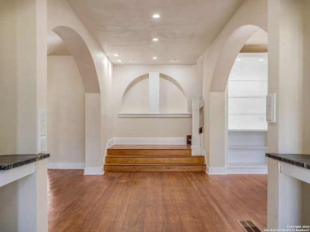 interior space with baseboards, visible vents, wood finished floors, and recessed lighting