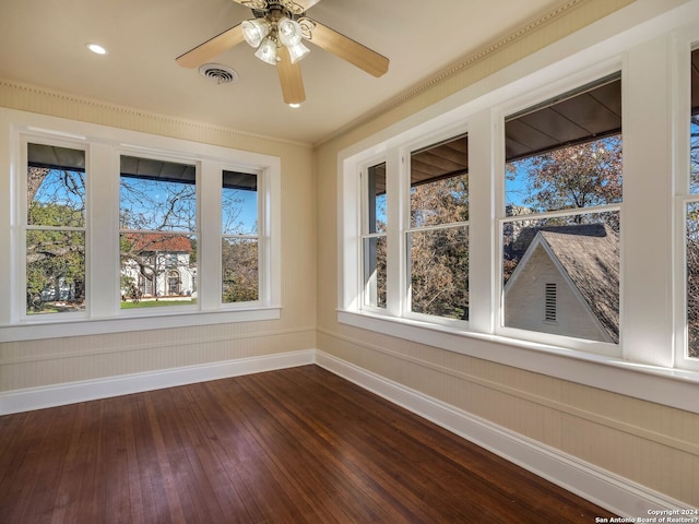 unfurnished sunroom featuring visible vents and a ceiling fan