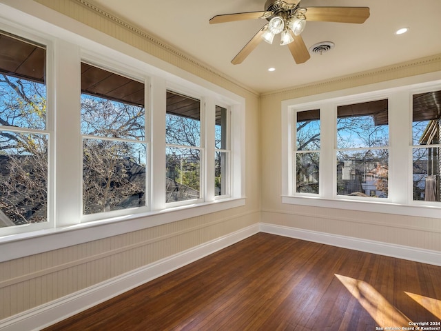 unfurnished sunroom with ceiling fan and visible vents