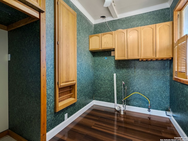 kitchen featuring dark wood finished floors, light brown cabinetry, ornamental molding, baseboards, and wallpapered walls