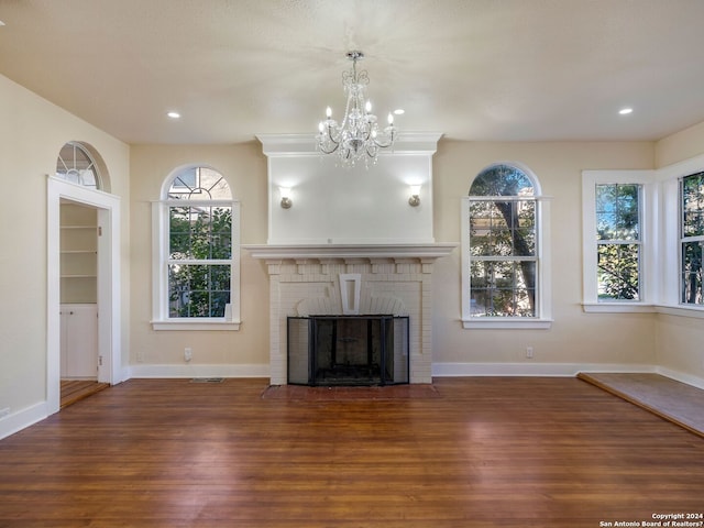 unfurnished living room with recessed lighting, a fireplace, wood finished floors, and baseboards