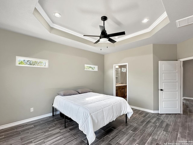 bedroom featuring wood tiled floor, multiple windows, visible vents, and a raised ceiling