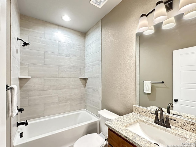 bathroom with shower / bathtub combination, visible vents, a textured wall, toilet, and vanity