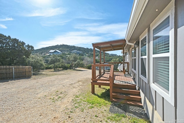 view of yard featuring fence and a mountain view