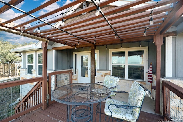 wooden terrace featuring outdoor dining area and a pergola