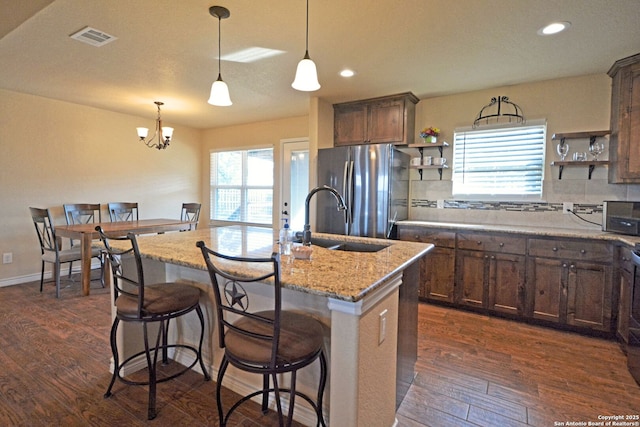 kitchen featuring tasteful backsplash, visible vents, dark wood-style floors, freestanding refrigerator, and open shelves