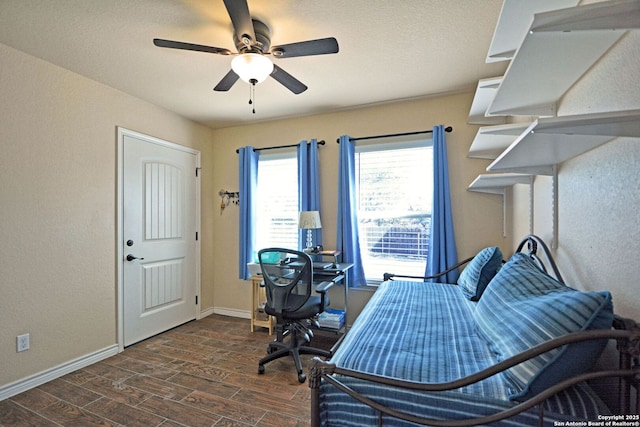 bedroom with ceiling fan, baseboards, and wood finished floors